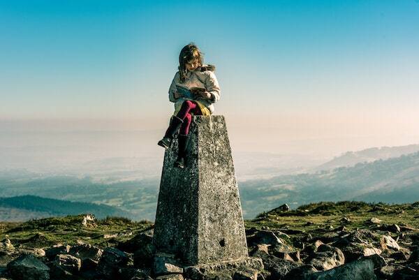 Girl on stone reading