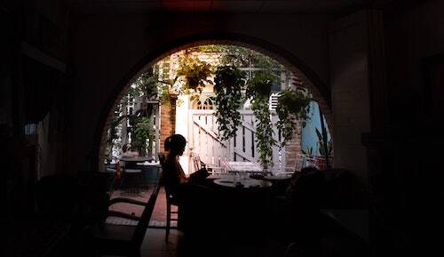 Woman reading under arch