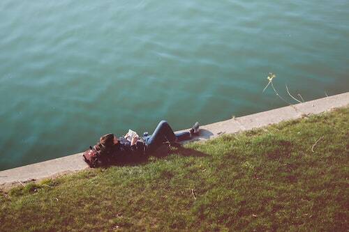 Woman reading by lake