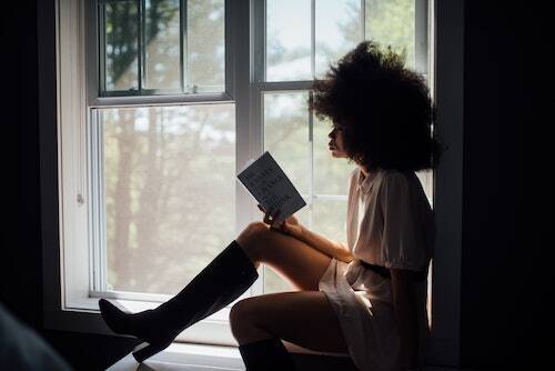 Woman reading by window