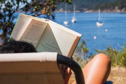 woman reading by lake