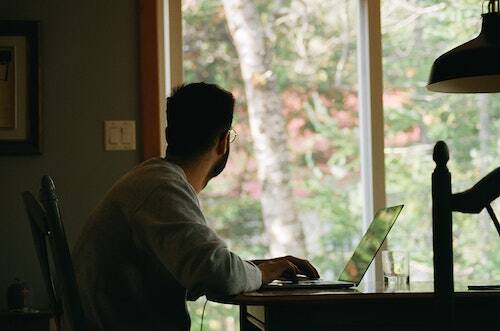 Man staring out of window