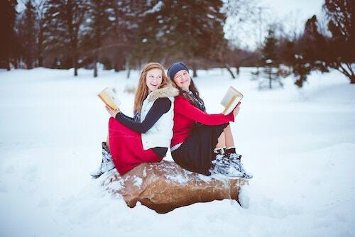 Girls reading in snow