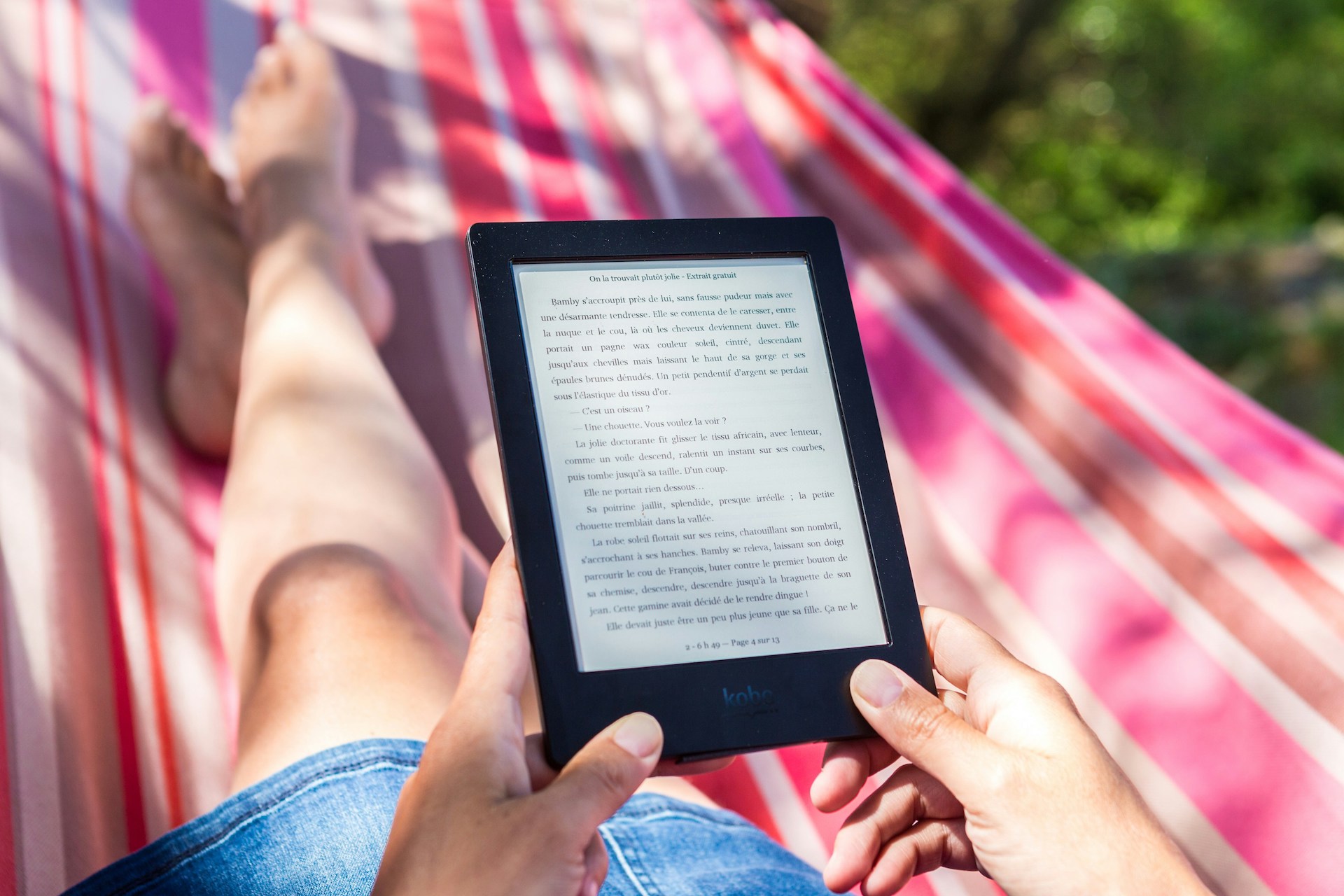 A person reading a story on an Amazon Kindle, showing how readers engage with your work as you build your readership.