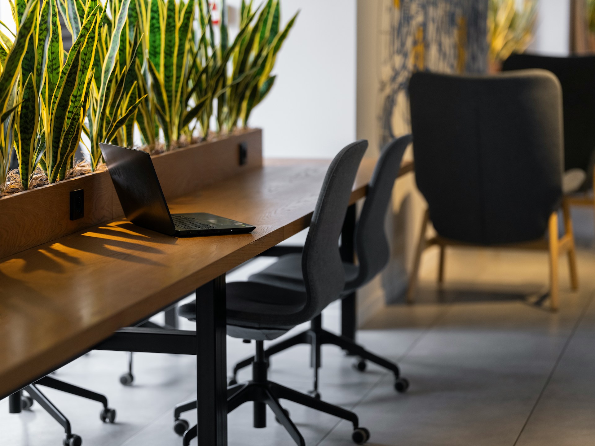 A computer on a desk in a modern office or coworking space, symbolizing a fresh start and the journey of a career change.