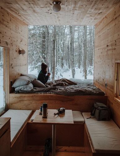 Cozy woman sipping tea while it snows