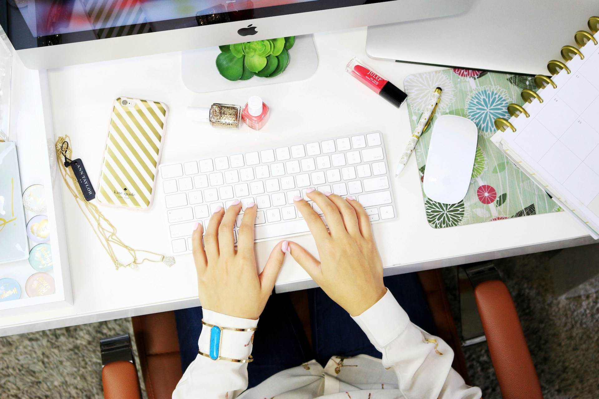 A person using a desktop computer, working on their content business.