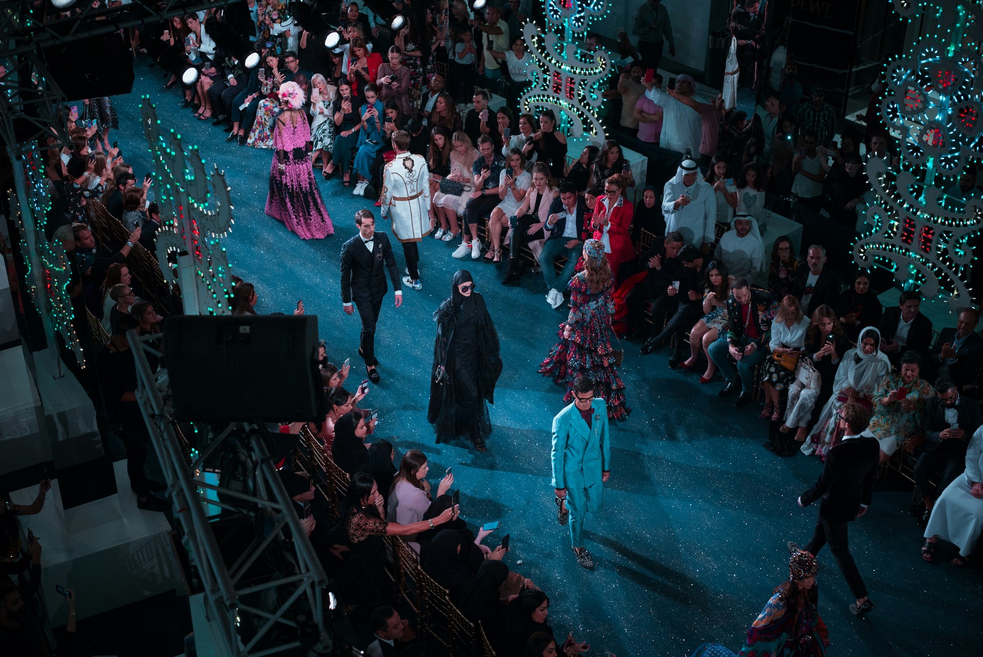 Models walking down the runway at a fashion show, capturing the fast-paced world of fashion journalism.