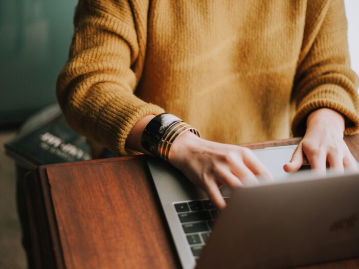 A person frantically typing on a laptop, illustrating the stress of a missed deadline.