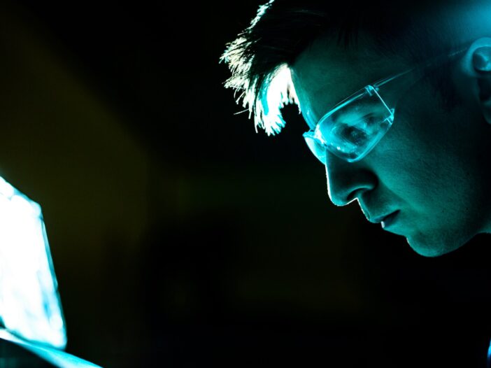 A scientist working in a lab, documenting findings for a science journalism piece.