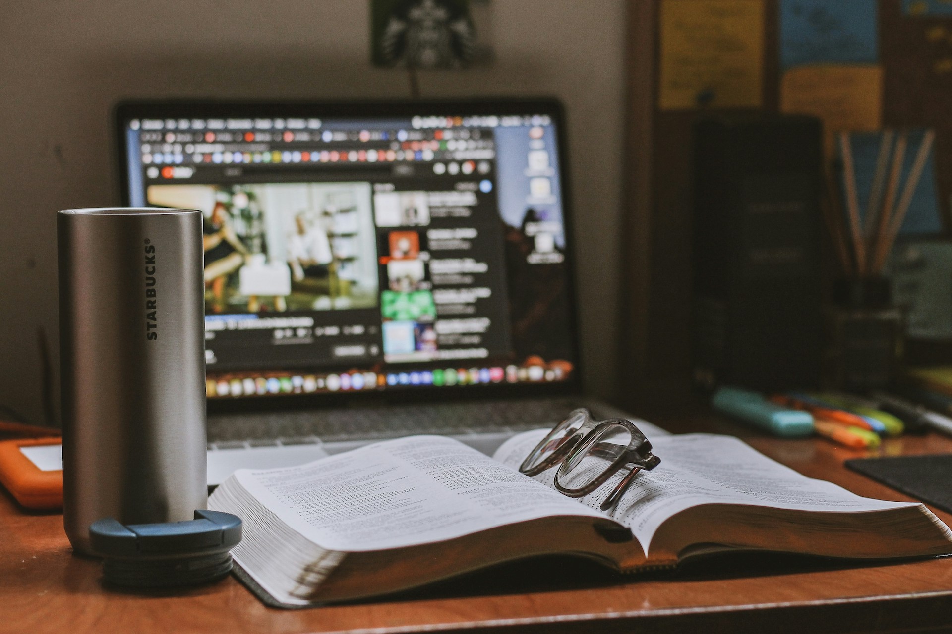 A coffee cup, notebook, and computer on a desk, representing the deep research and storytelling of long-form journalism.